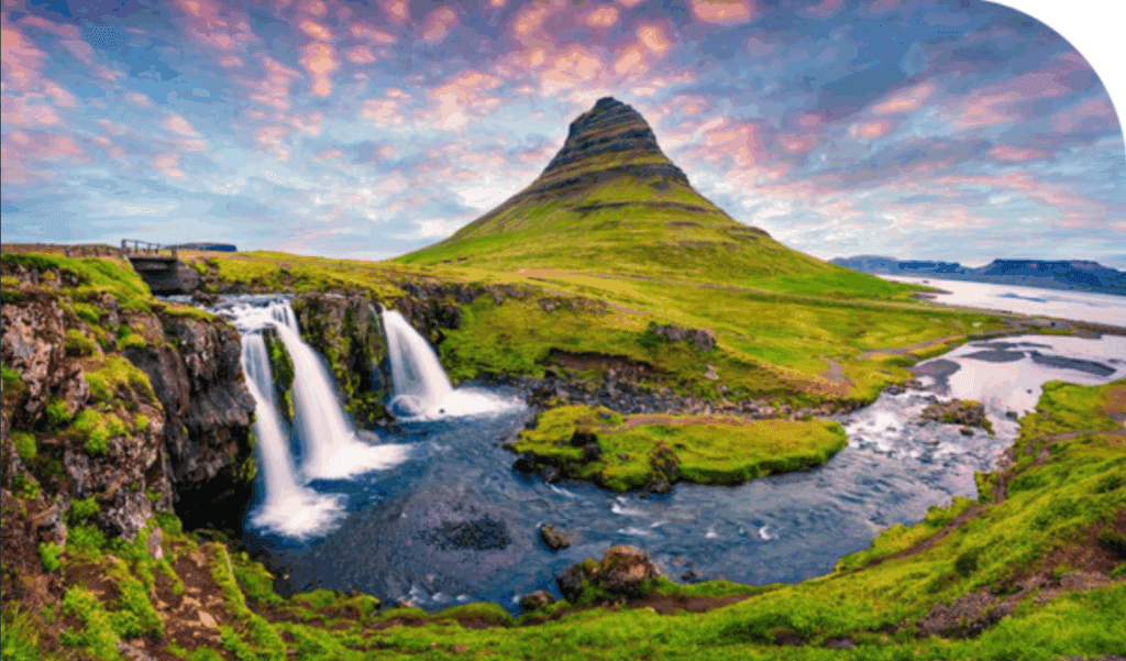 Waterfalls amongst green fields and hills.